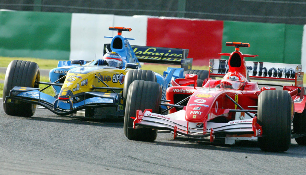 Ferrari driver Michael Schumacher leads Renault's Fernando Alonso on track during the 2005 Japanese Grand Prix at Suzuka