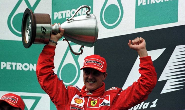 22 Oct 2000:  Michael Schumacher of Germany and Ferrari holds aloft the winners trophy at the Malaysian Formula One Grand Prix at the Sepang circui...