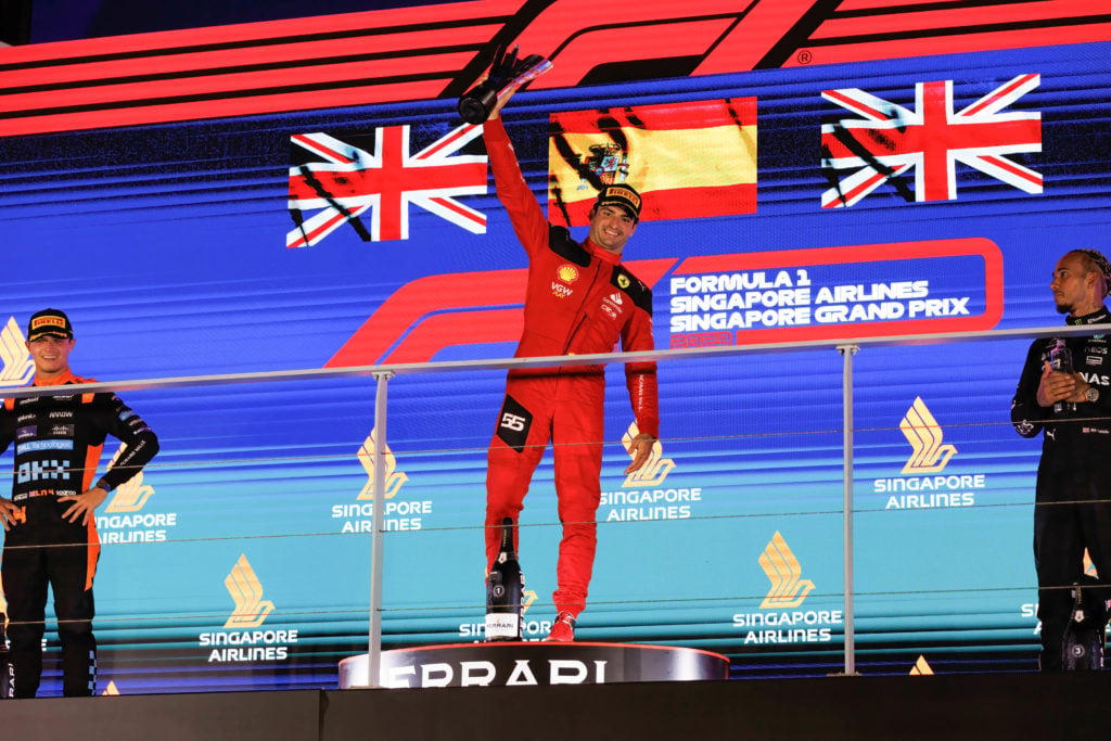 Carlos Sainz of Spain celebrates on the podium after winning