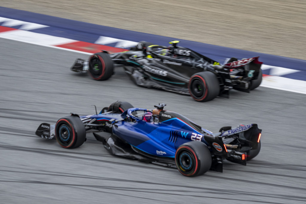 Mercedes driver Lewis Hamilton with Alex Albon of Williams in practice at 2023 F1 Austrian GP