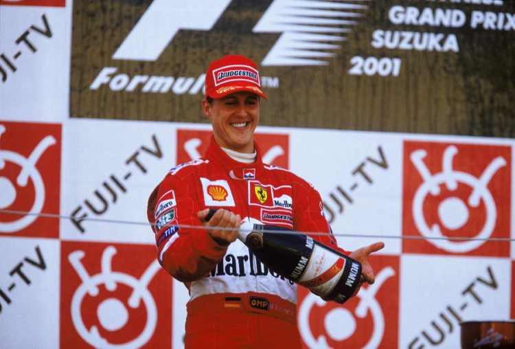 14 Oct 2001:  Ferrari driver Michael Schumacher of Germany celebrates on the Podium after winning the Formula One Japanese Grand Prix held at the S...