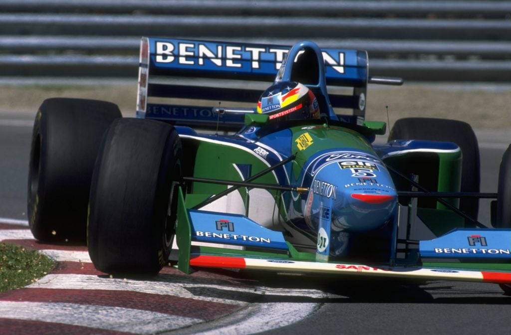 Michael Schumacher cuts close to a corner in his Benetton Ford en route to winning the 1994 F1 Canadian GP