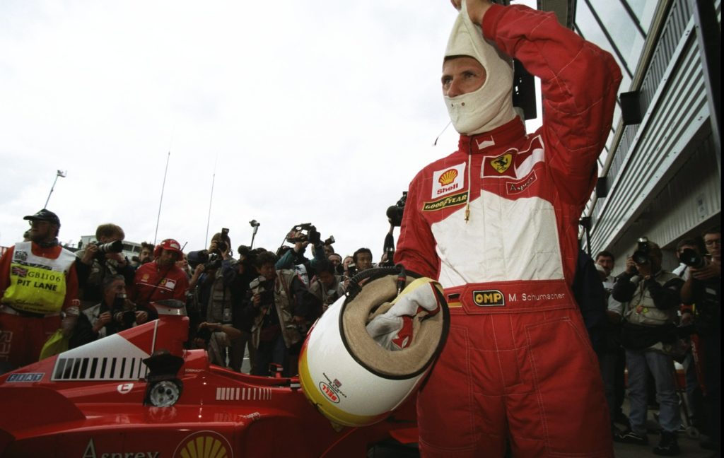 Michael Schumacher of Germany and Ferrari takes off his helmet after winning