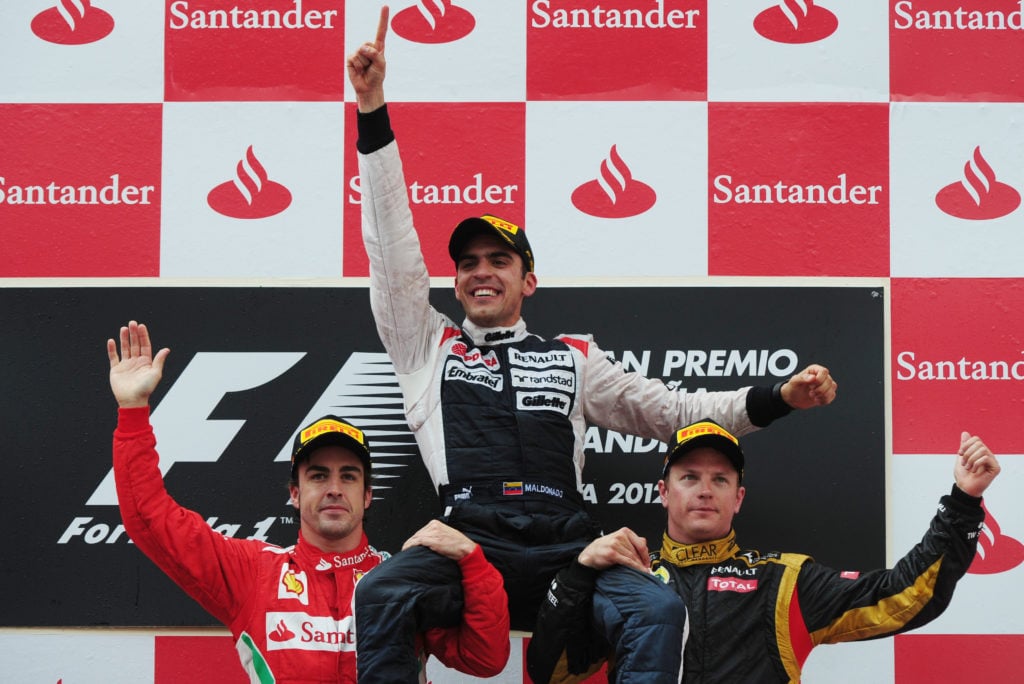 Fernando Alonso and Kimi Raikkonen lift Pastor Maldonado on the podium at the 2012 Spanish Grand Prix