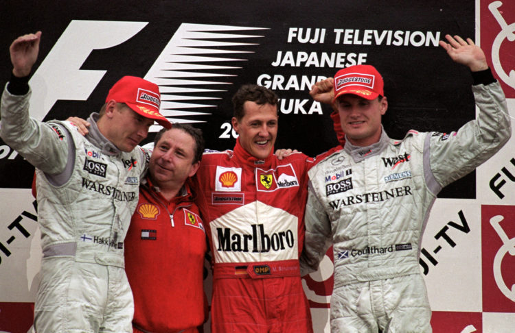 8 Oct 2000:  (L to R) Mika Hakkinen, Jean Todt, Michael Schumacher and David Coulthard on the podium after the Japanese Formula One Grand Prix in S...