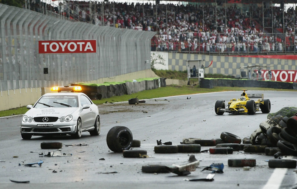 Fisichella drives through crash debris
