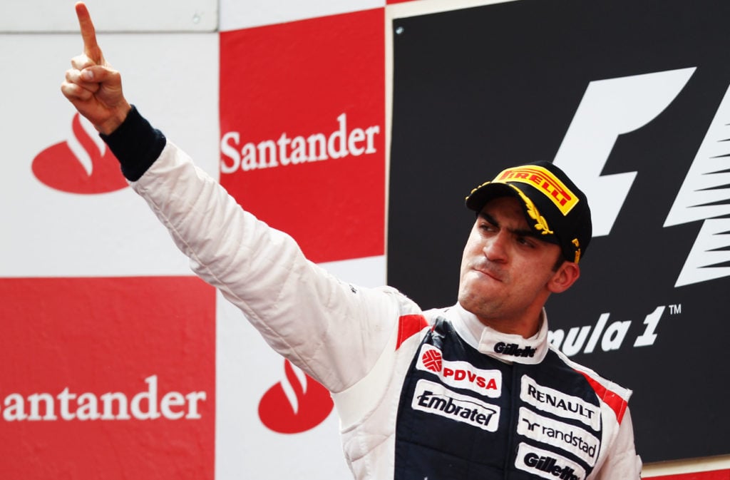 Pastor Maldonado celebrates on the podium after winning the 2012 Spanish Grand Prix