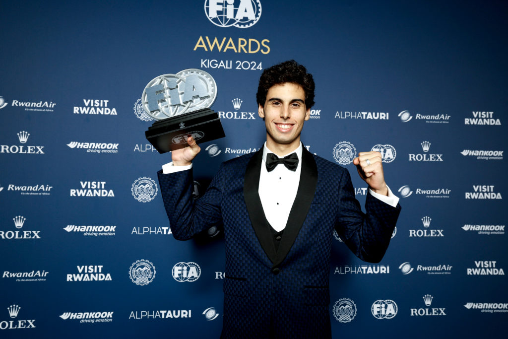 Gabriel Bortoleto holds up his trophy after winning the 2024 FIA Rookie of the Year award