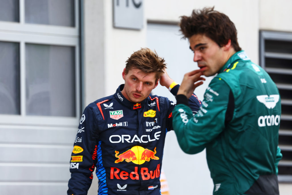 Red Bull Racing and Aston Martin drivers Max Verstappen and Lance Stroll look on after the 2024 F1 Austrian Grand Prix