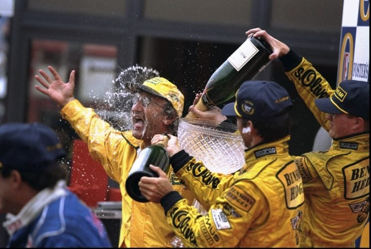 30 Aug 1998:  Jordan boss Eddie Jordan (left) is sprayed with champagne by winner Damon Hill (right front) of Great Britain and Ralf Schumacher (re...