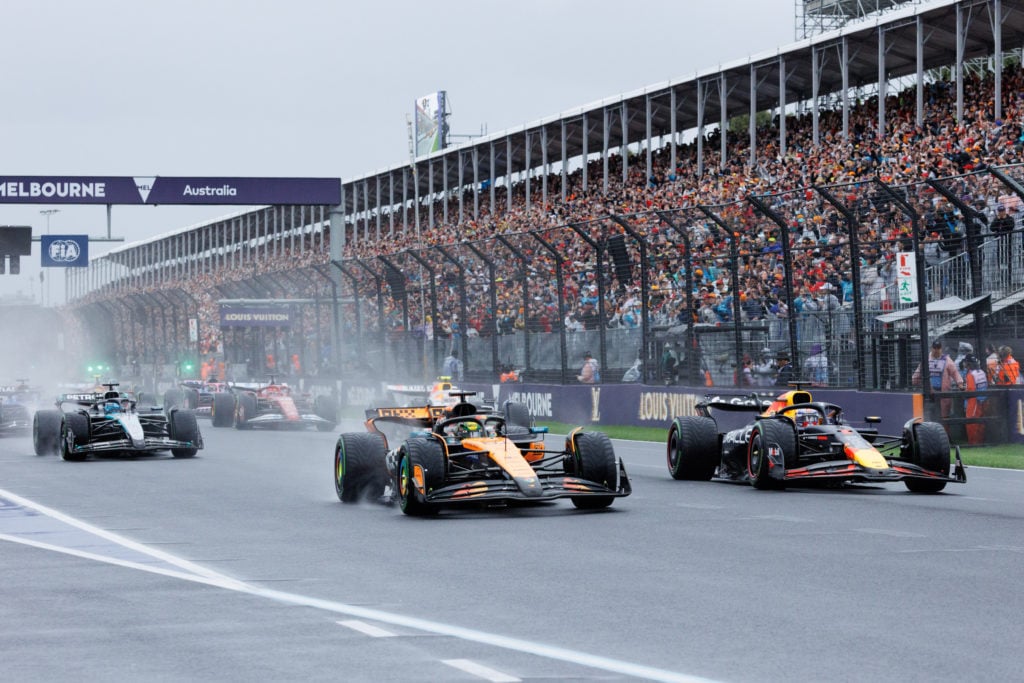 Oscar Piastri of Australia (L) drives the (81) McLaren