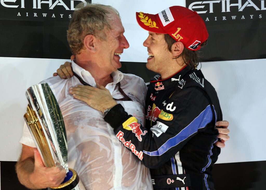 Red Bull's Sebastian Vettel celebrates winning the 2010 Formula 1 championship with Helmut Marko at the Abu Dhabi Grand Prix