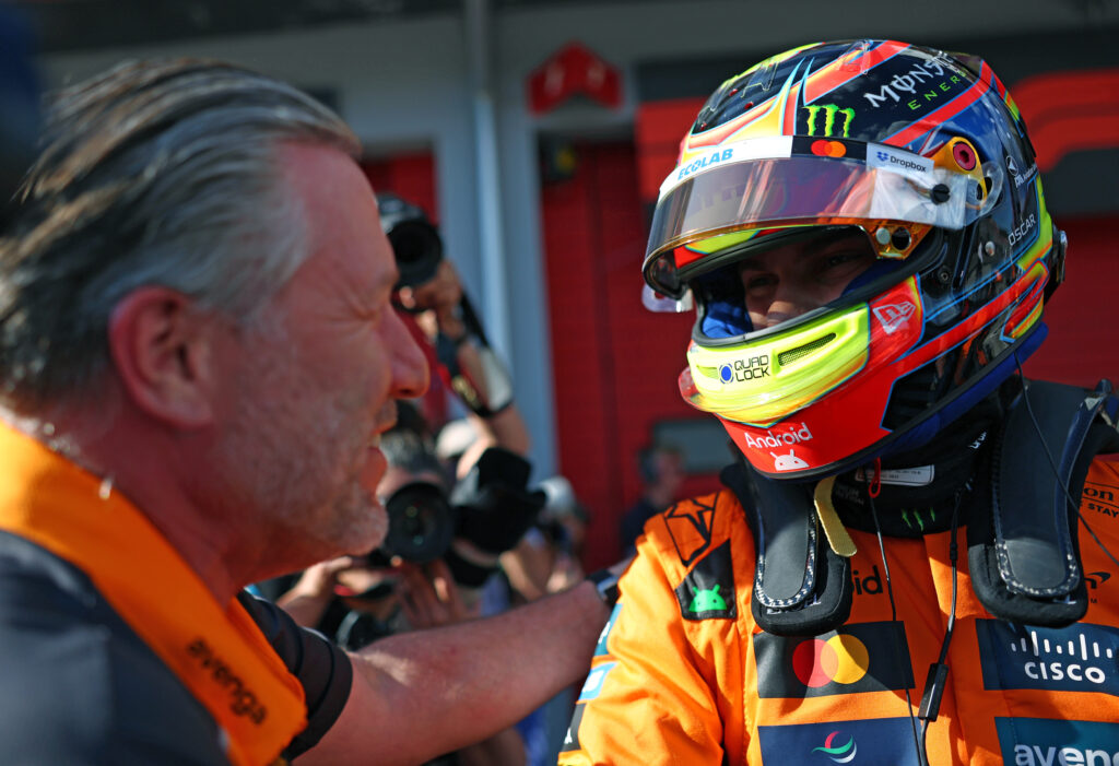 McLaren driver Oscar Piastri speaks to CEO Zak Brown after scoring pole for the 2025 F1 Emilia Romagna Grand Prix at Imola