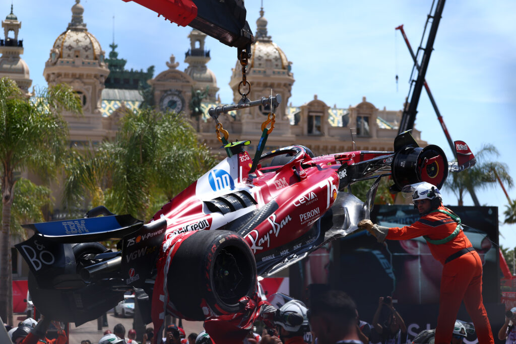 Marshalls lift the Ferrari of Lewis Hamilton after his crash in FP3 for the 2025 F1 Monaco Grand Prix