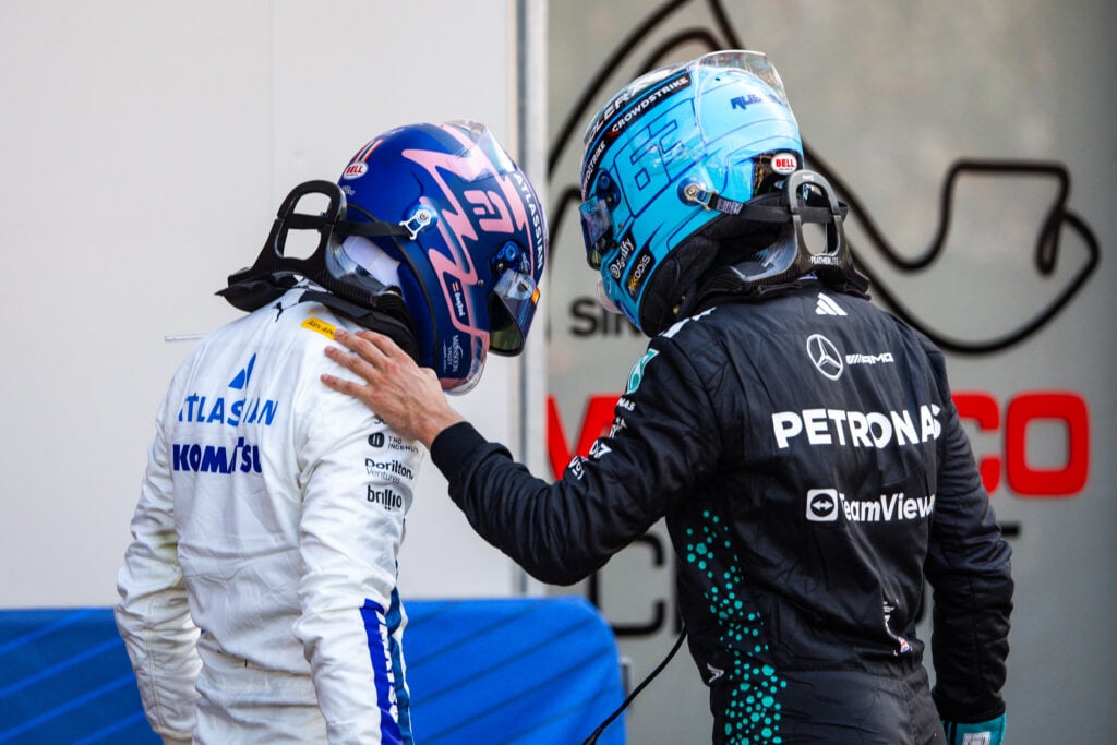 Mercedes driver George Russell putting his hand on Williams driver Alex Albon's shoulder after the 2025 Monaco Grand Prix