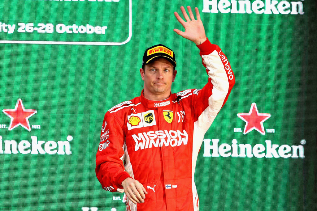 Kimi Raikkonen celebrates on the podium during his time at Ferrari
