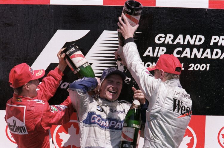 10 Jun 2001:  Ferrari driver Michael Schumacher (left) of Germany and McLaren-Mercedes driver Mika Hakkinen (right) of Finland shower race winner W...