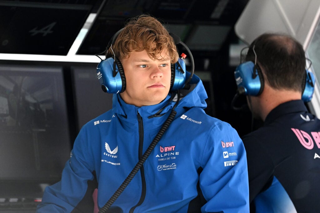 Paul Aron of Alpine watches on from the pit wall