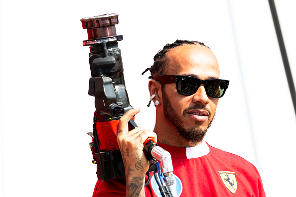 Ferrari driver Lewis Hamilton holds a wheel gun at the 2025 F1 Canadian Grand Prix
