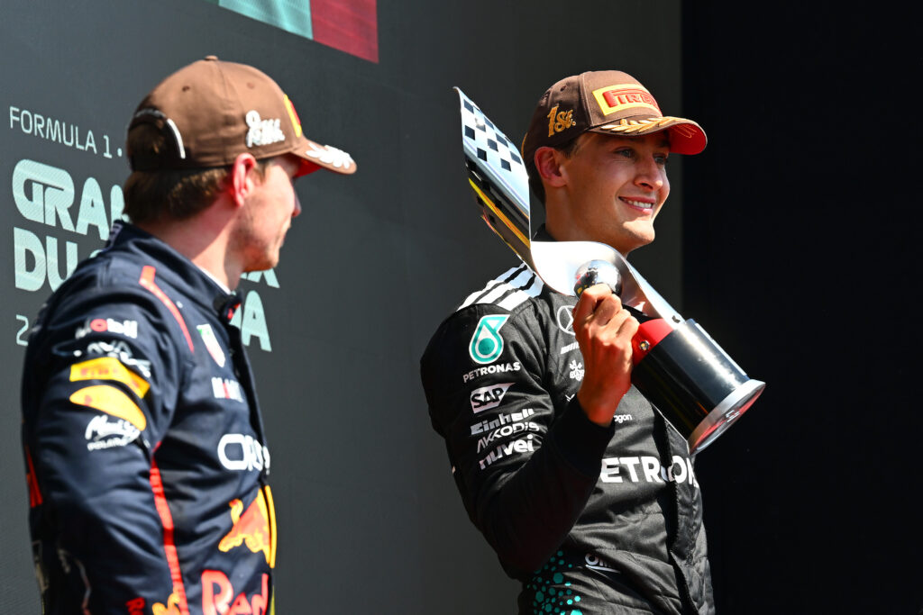 Red Bull driver Max Verstappen looks on as George Russell of Mercedes celebrates winning the 2025 F1 Canadian Grand Prix