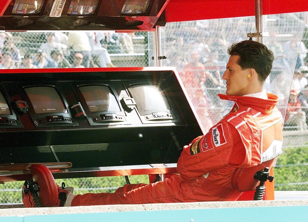 Ferrari driver Michael Schumacher sitting on the pit wall at the 1998 Formula 1 Japanese Grand Prix