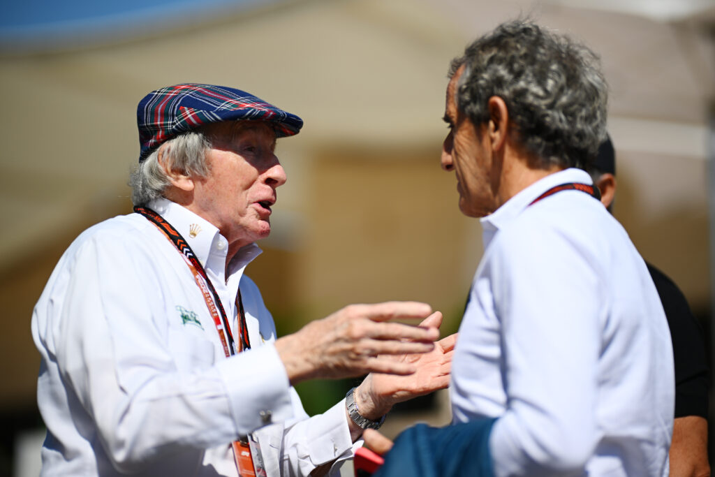 Jackie Stewart speaking to Alain Prost at the 2025 Formula 1 British Grand Prix