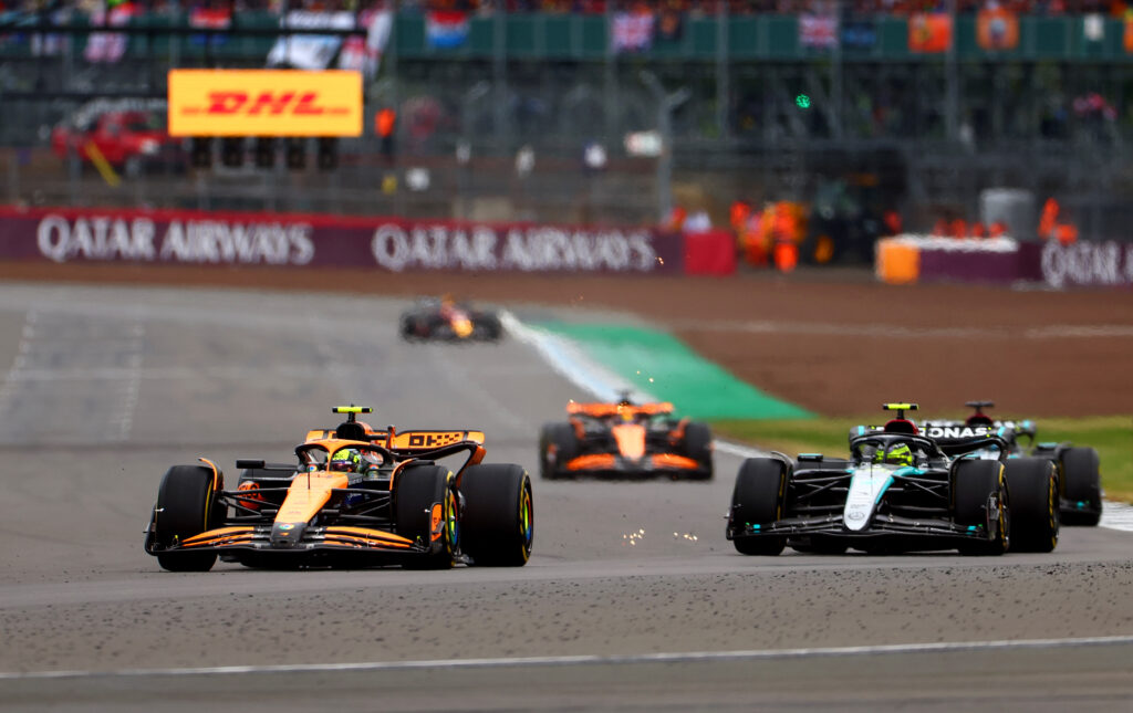 McLaren driver Lando Norris overtakes Lewis Hamilton of Mercedes in the 2024 F1 British Grand Prix at Silverstone