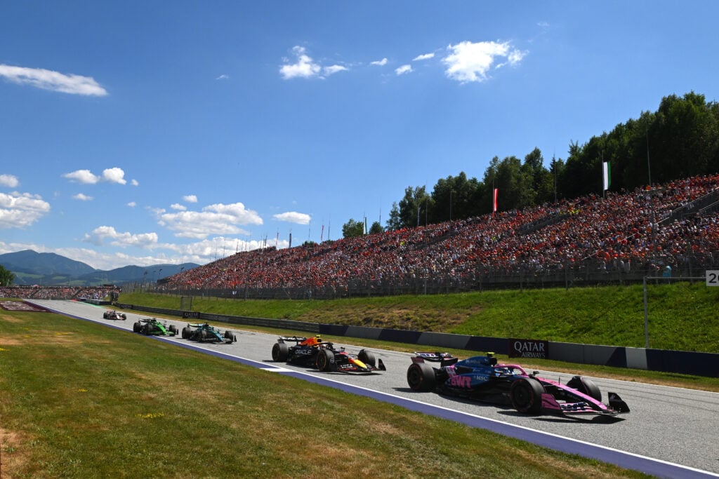 Alpine driver Franco Colapinto and Red Bull Racing driver Yuki Tsunoda racing at the 2025 Formula 1 Austrian Grand Prix