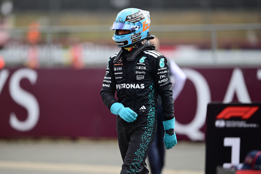 George Russell of Mercedes walks in parc ferme