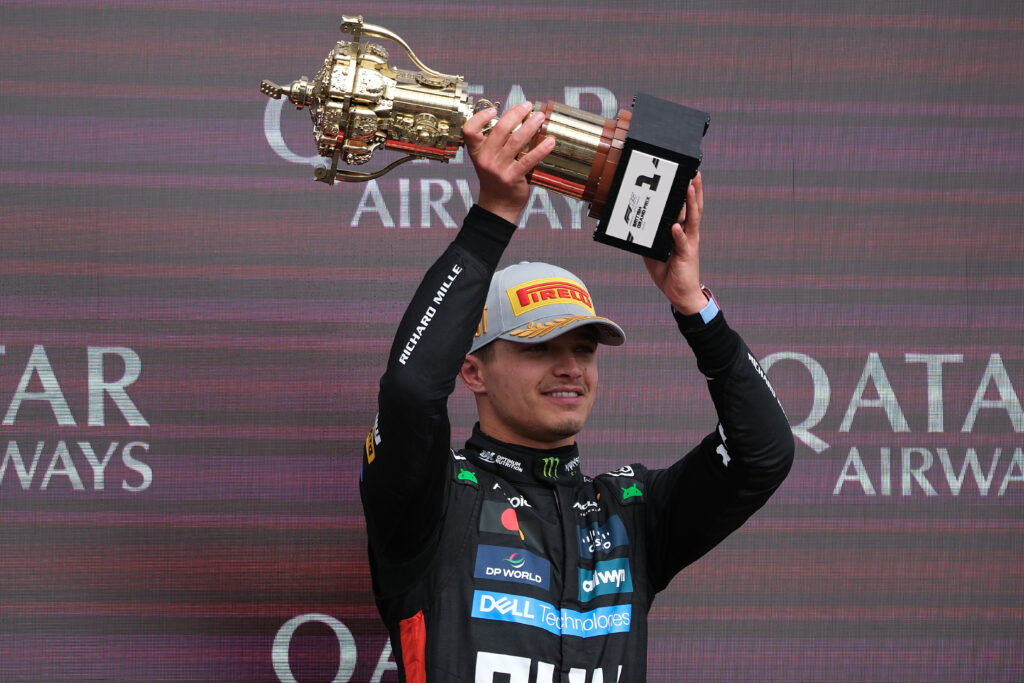McLaren driver Lando Norris celebrating on the podium at the 2025 Formula 1 British Grand Prix