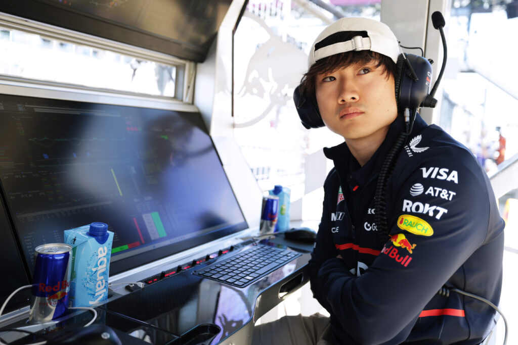 Yuki Tsunoda sits on the Red Bull pitwall