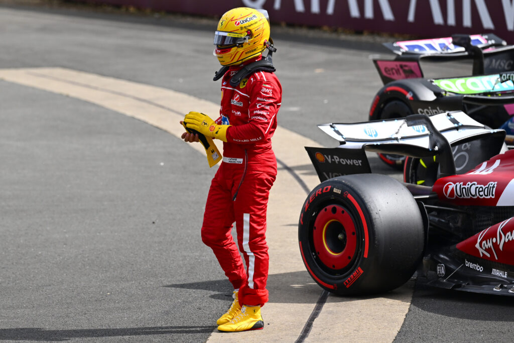 Lewis Hamilton of Ferrari walks in parc ferme