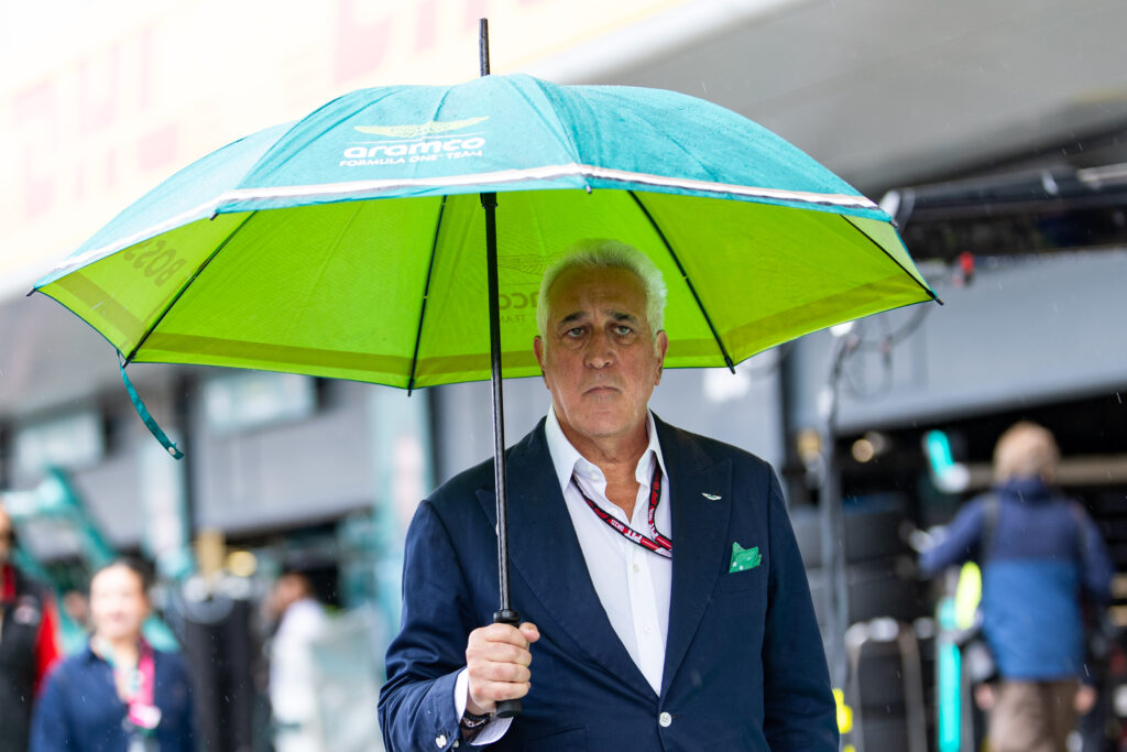 Lawrence Stroll of Aston Martin walks in the F1 paddock