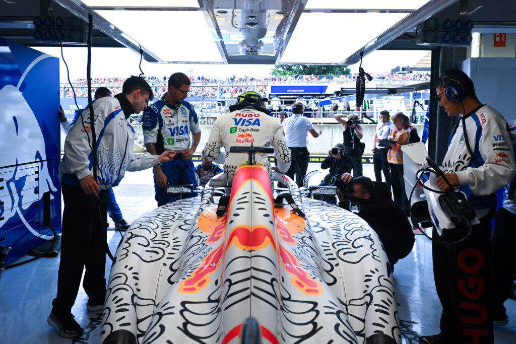Isack Hadjar getting into his VCARB-02 in the Racing Bulls garage at the 2025 British Grand Prix