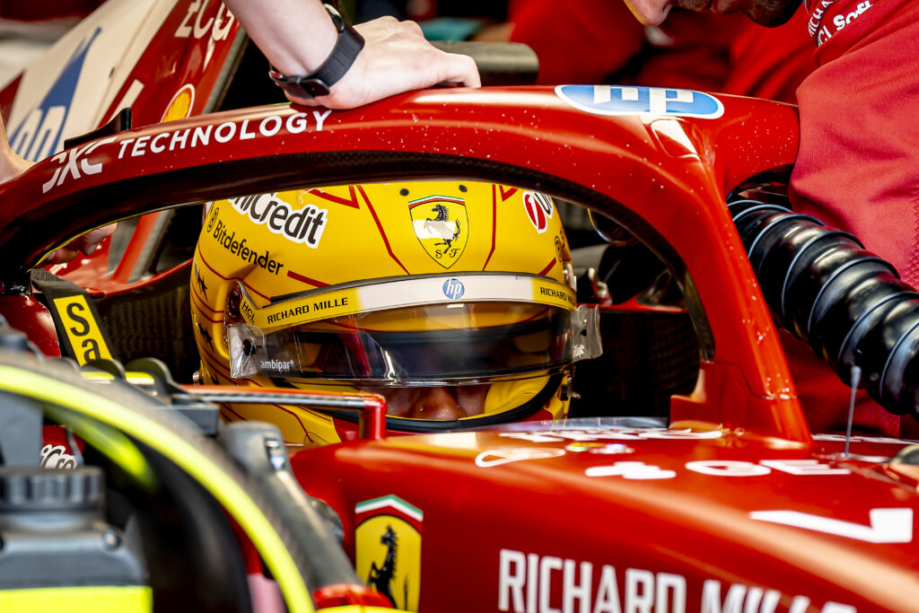 Lewis Hamilton sits in the Ferrari F1 cockpit