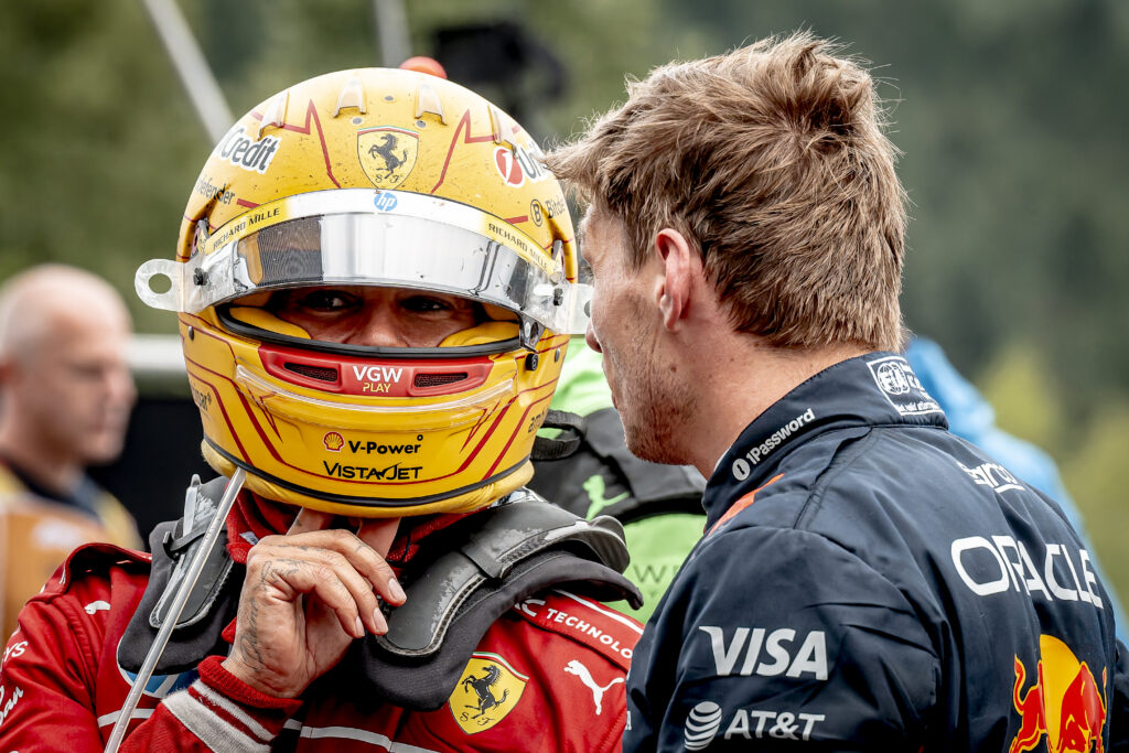 Lewis Hamilton of Ferrari speaks to Max Verstappen of Red Bull