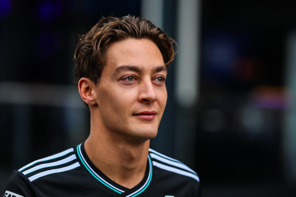 George Russell of Mercedes walks in the F1 paddock
