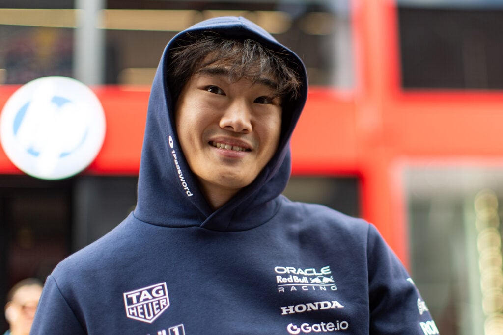 Yuki Tsunoda of Red Bull smiles in the F1 paddock
