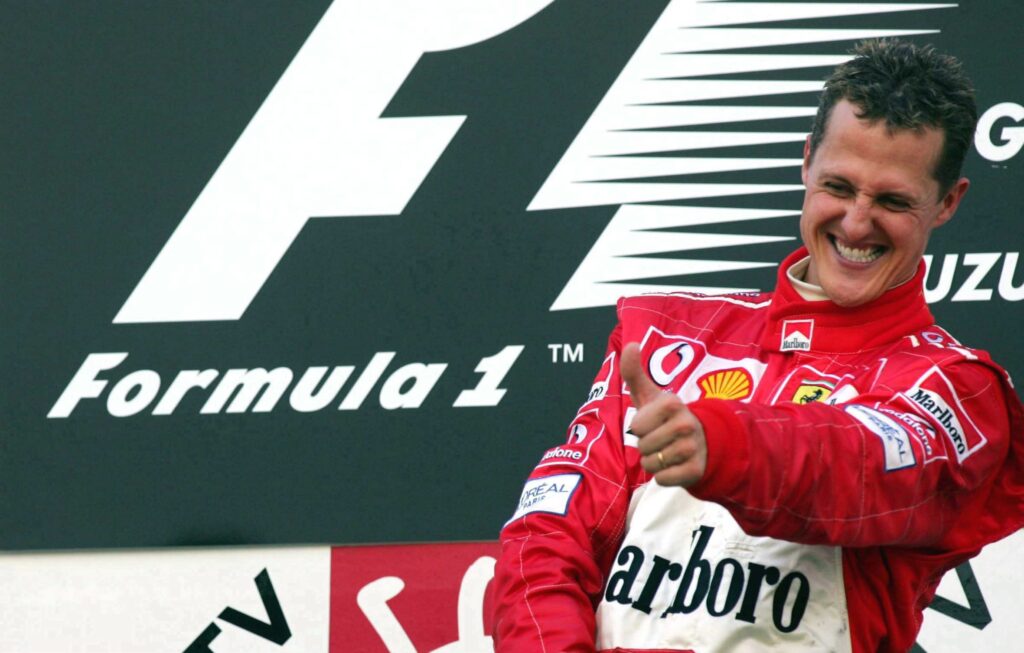 Ferrari driver Michael Schumacher celebrates winning the 2004 Japanese Grand Prix at Suzuka