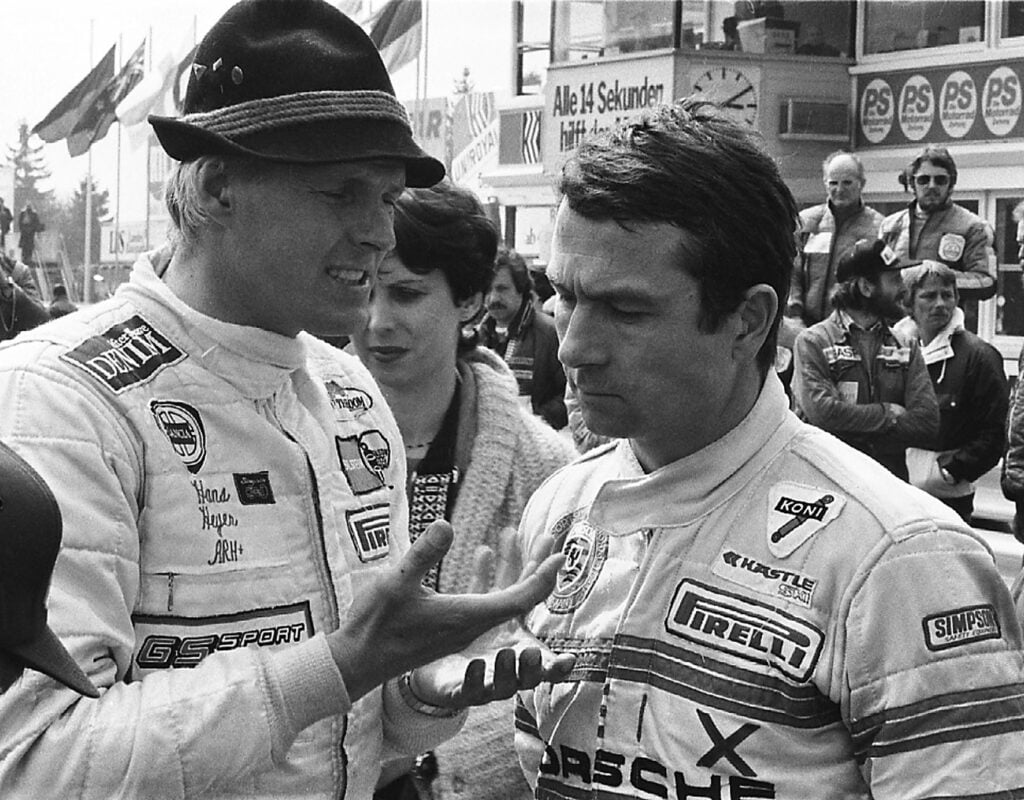 Hans Heyer and Bob Wolleck speaking at a racing event in 1980