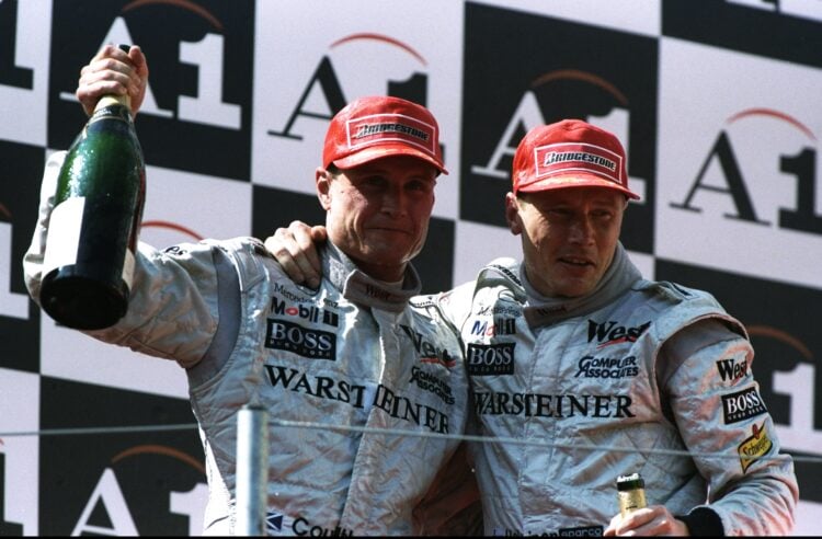 26 Jul 1998:  McLaren-Mercedes drivers David Coulthard (left) of Great Britain and Mika Hakkinen of Finland celebrate with champagne after the Aust...