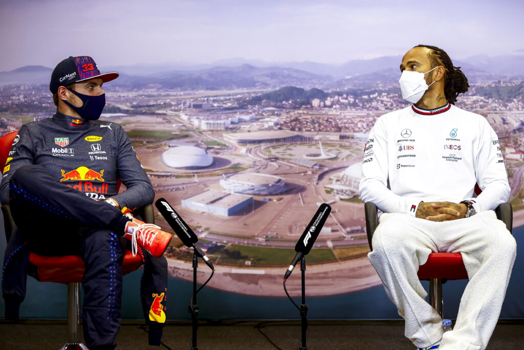 Lewis Hamilton glances at Red Bull driver Max Verstappen during a press conference in 2021