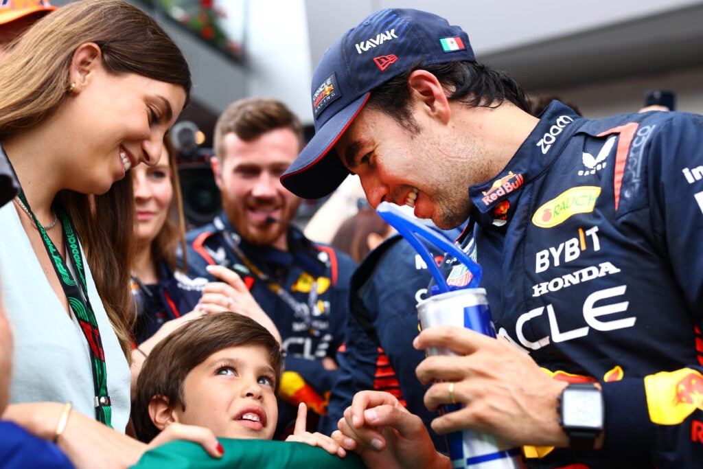 Sergio Perez celebrates with wife Carola Martinez and son Sergio Jr after third place finish at the 2023 Austrian Grand Prix