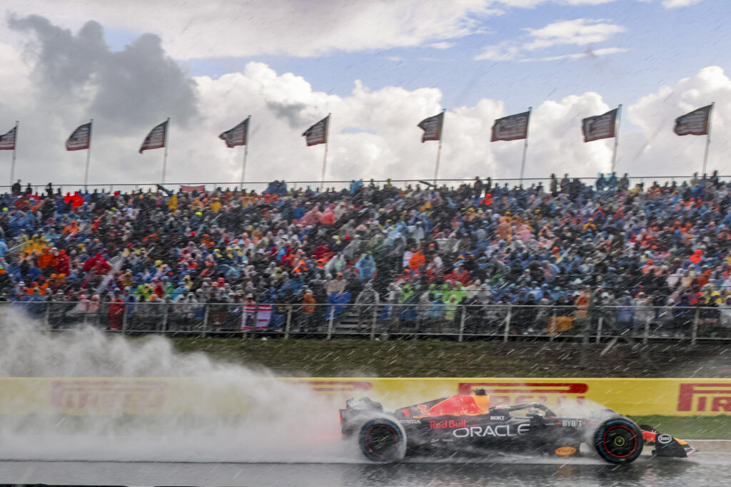 Max Verstappen drives past grand stand during heavy rain shower at the Dutch Grand Prix