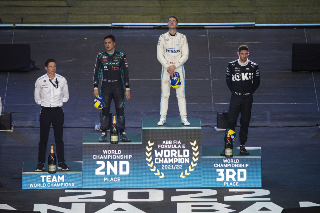 Stoffel Vandoorne stands on the podium as the 2021-22 Formula E world champion