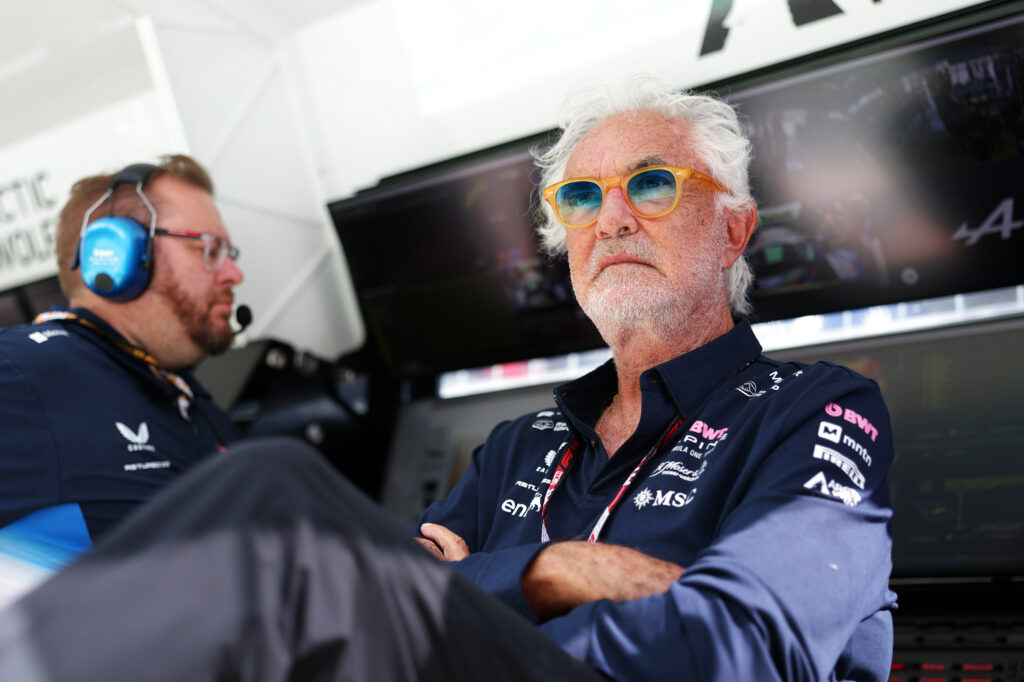 Flavio Briatore sits on the Alpine pit wall