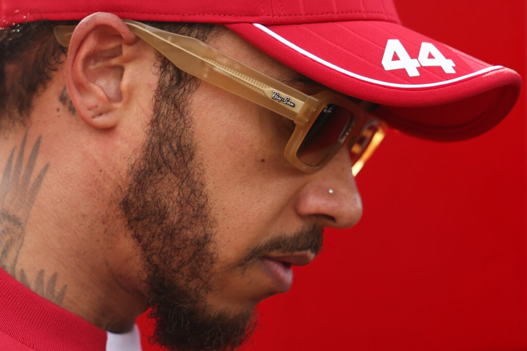 Lewis Hamilton of Ferrari bows his head while wearing sunglasses