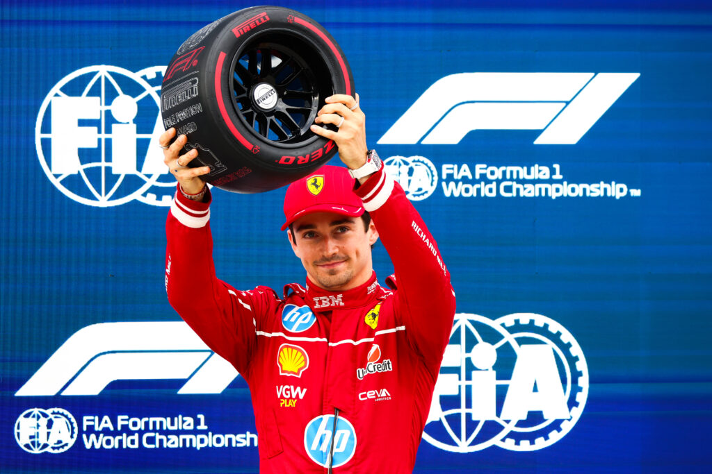 Charles Leclerc of Ferrari lifts the F1 pole position trophy