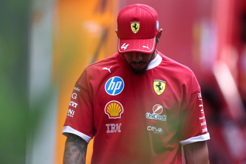 Lewis Hamilton of Scuderia Ferrari looks dejected in the