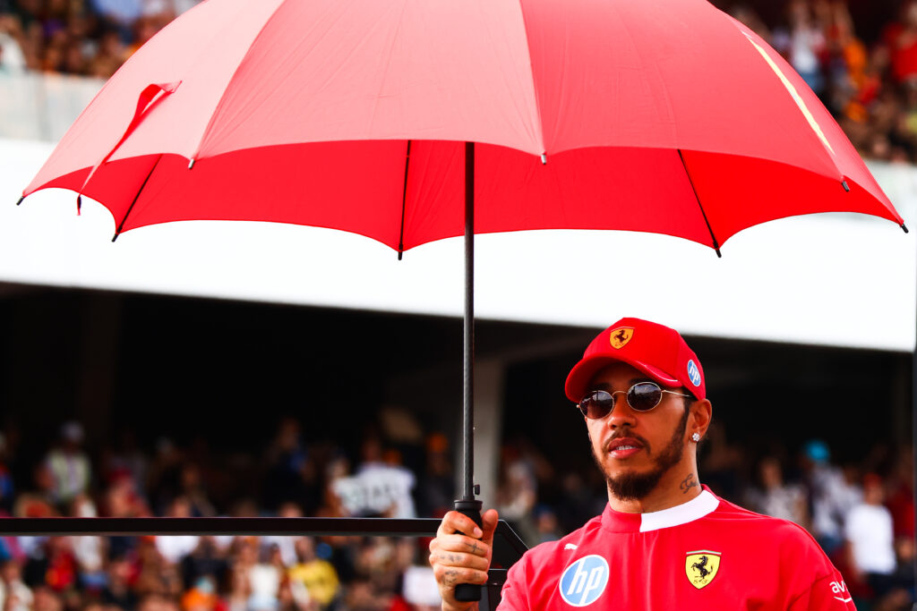 Lewis Hamilton of Ferrari stands on the drivers' parade truck
